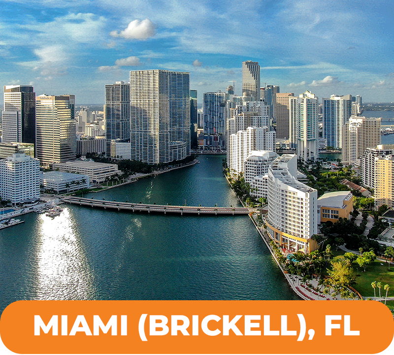 Miami (Brickell) skyline with high-rise buildings along a river, blue water, and orange text overlay.