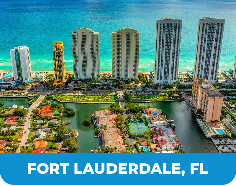 Aerial view of Fort Lauderdale, FL coastline with high-rise buildings, waterways, and turquoise ocean