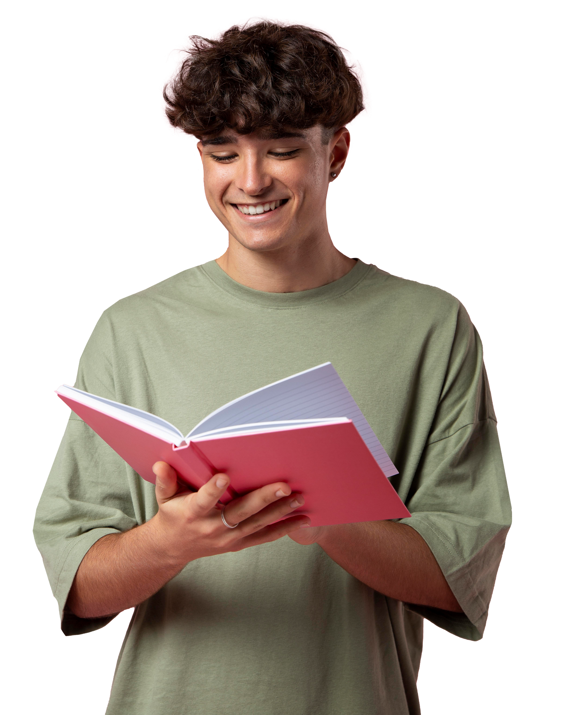 A young man is reading a pink book and smiling.