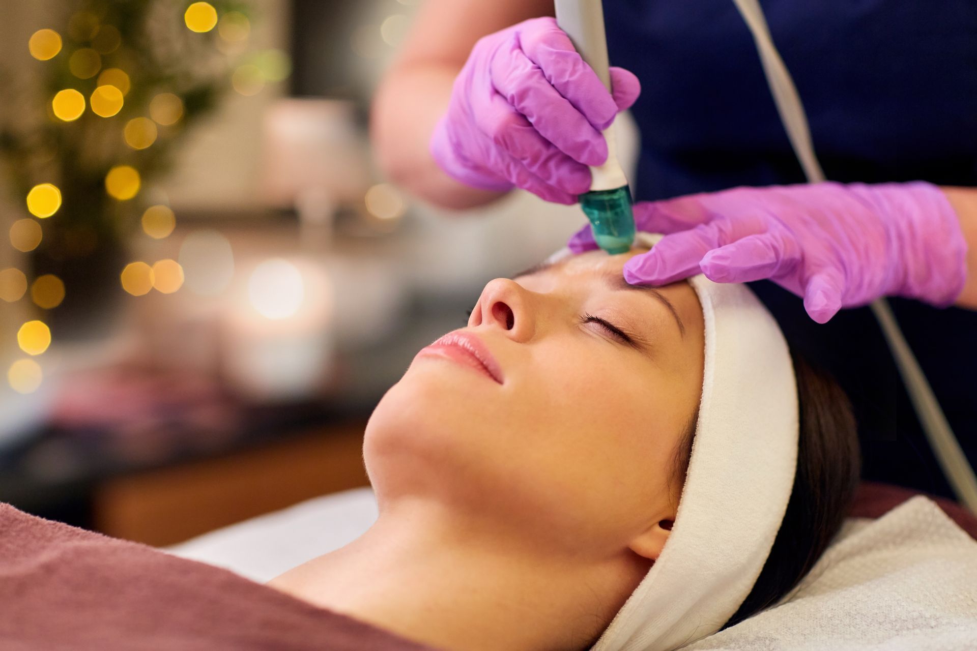 A woman is getting a facial treatment at a beauty salon.