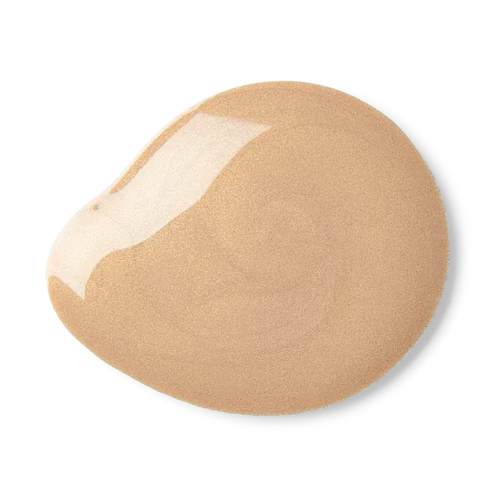 A close up of a swatch of foundation on a white background.