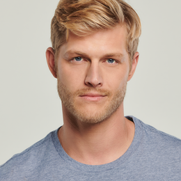 A man with a beard is wearing a grey t-shirt