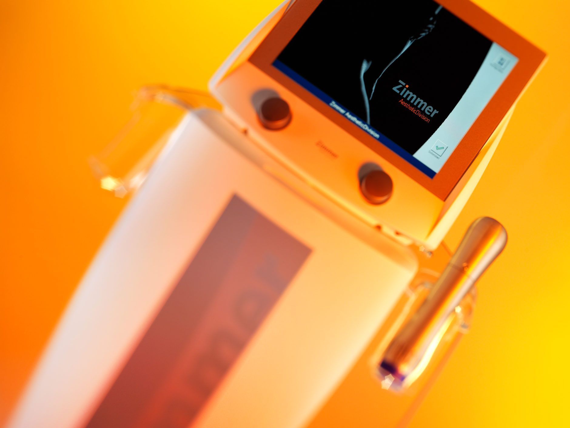 An orange and white device with zimmer on the screen