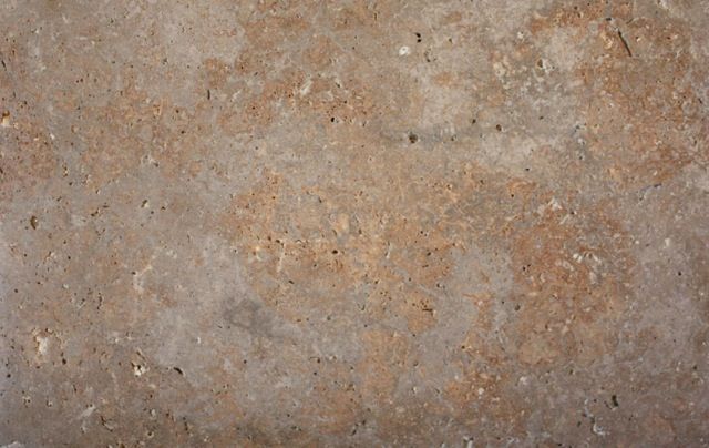 Brown and tan mottled stone surface.