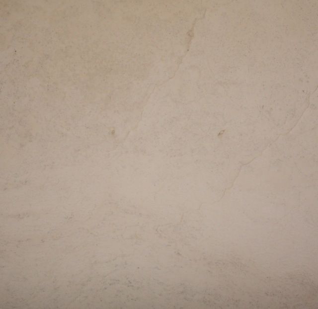 Textured beige wall, possibly stucco or plaster.