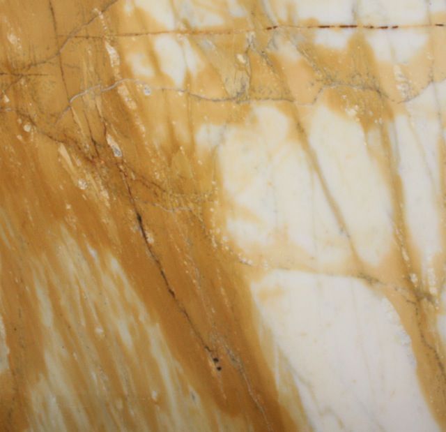 Yellow and white marble with brown veining.