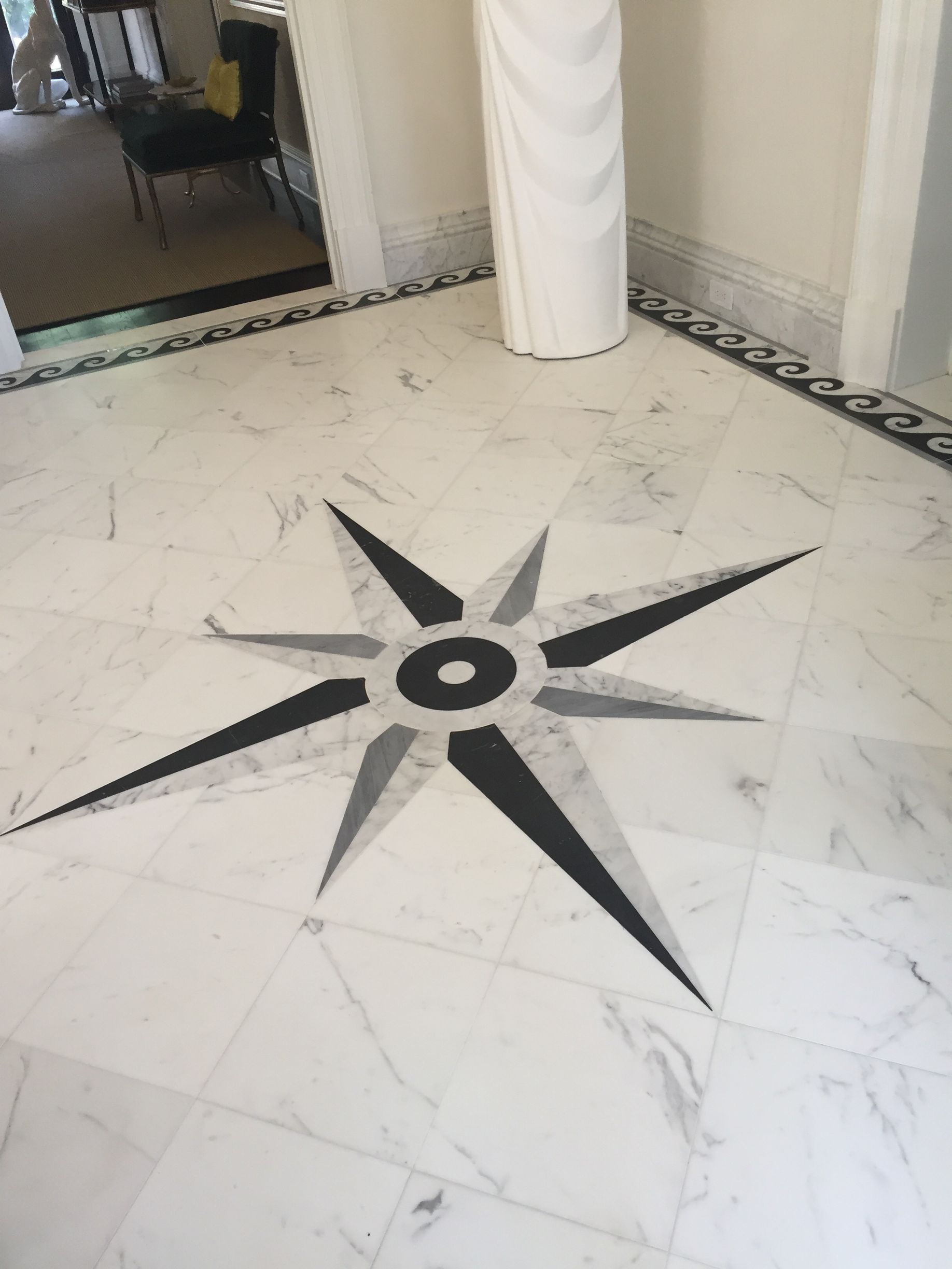 Marble floor with a black and gray starburst design.