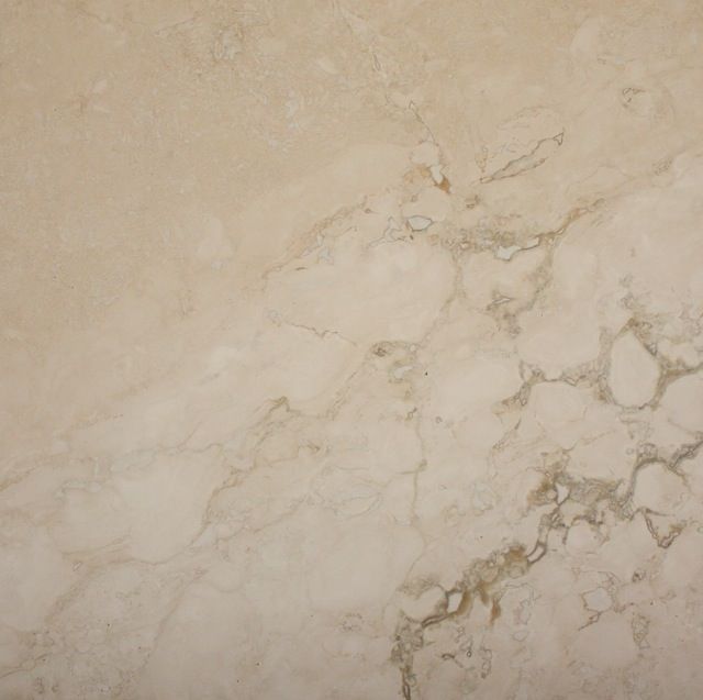 Cream-colored marble with tan and gray veining.