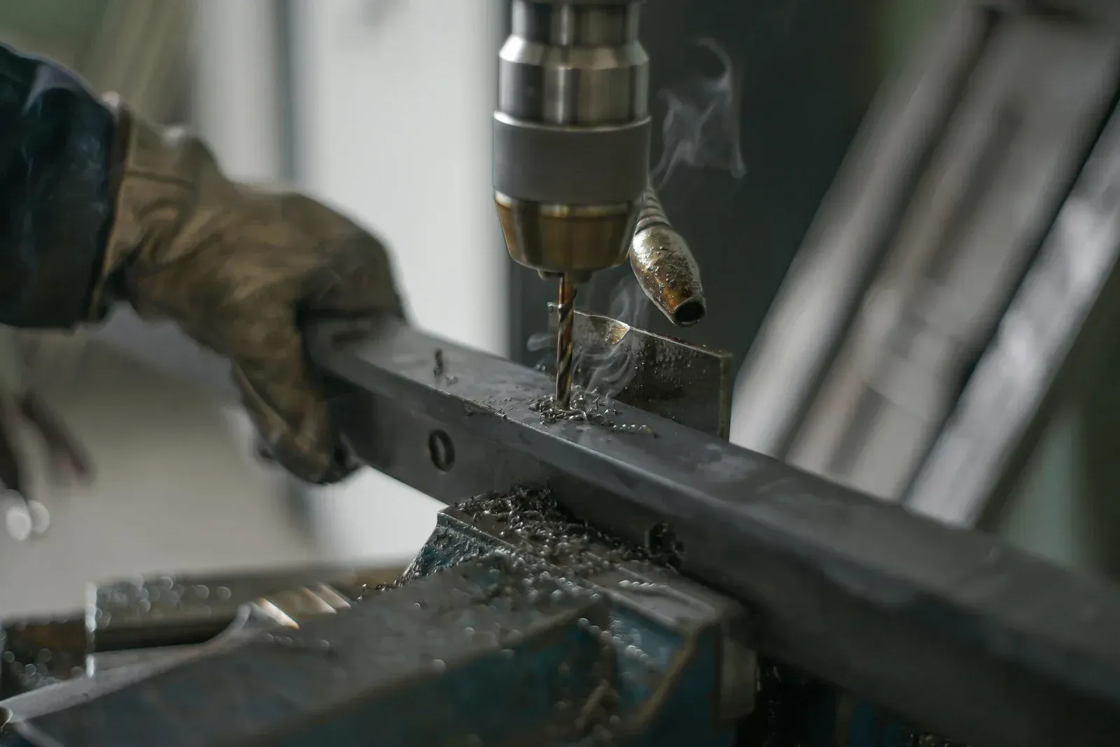 Person welding metal frame corner, wearing gloves.