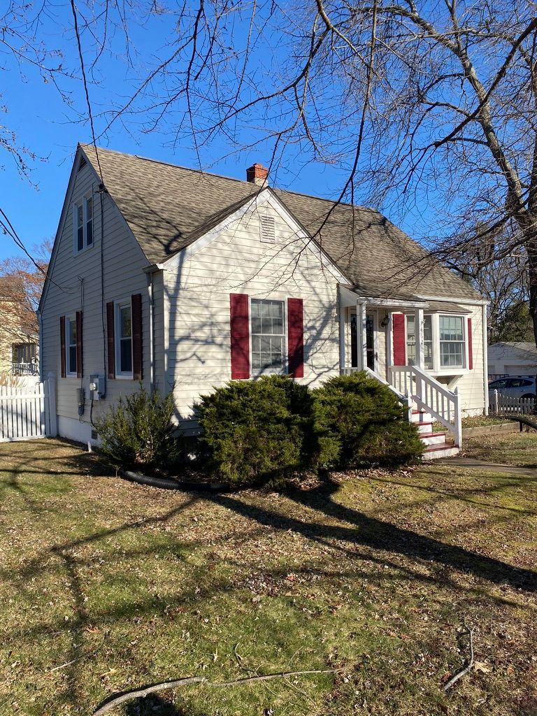 A house with a large lawn in front of it