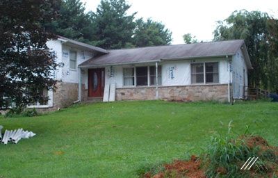 A house with a large lawn in front of it