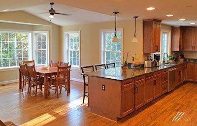 A kitchen with a dining table and chairs and a large island.