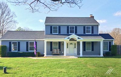 A large house with a large lawn in front of it.