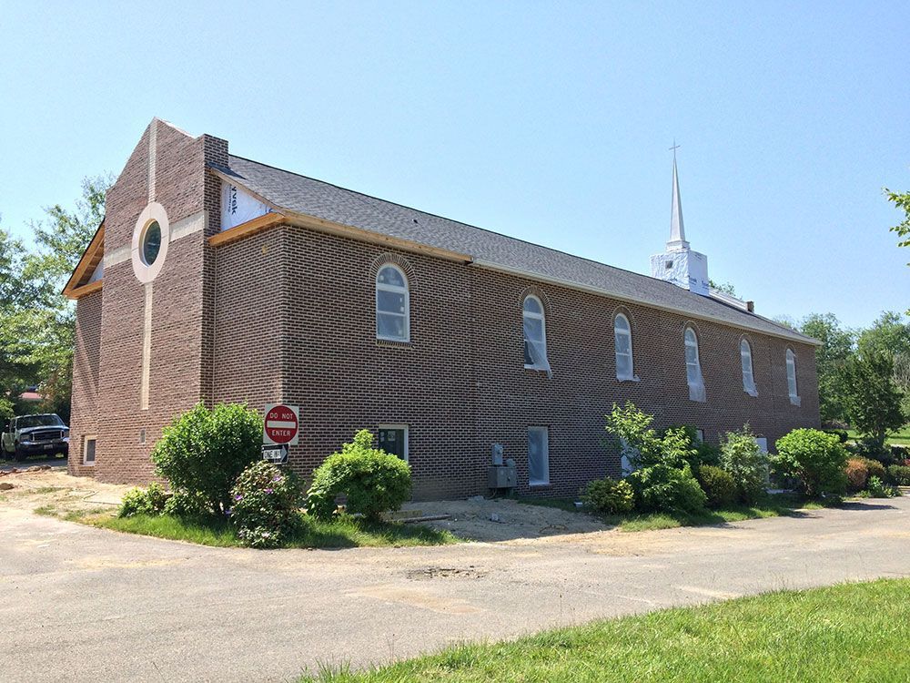 A large brick building with a steeple on top of it.