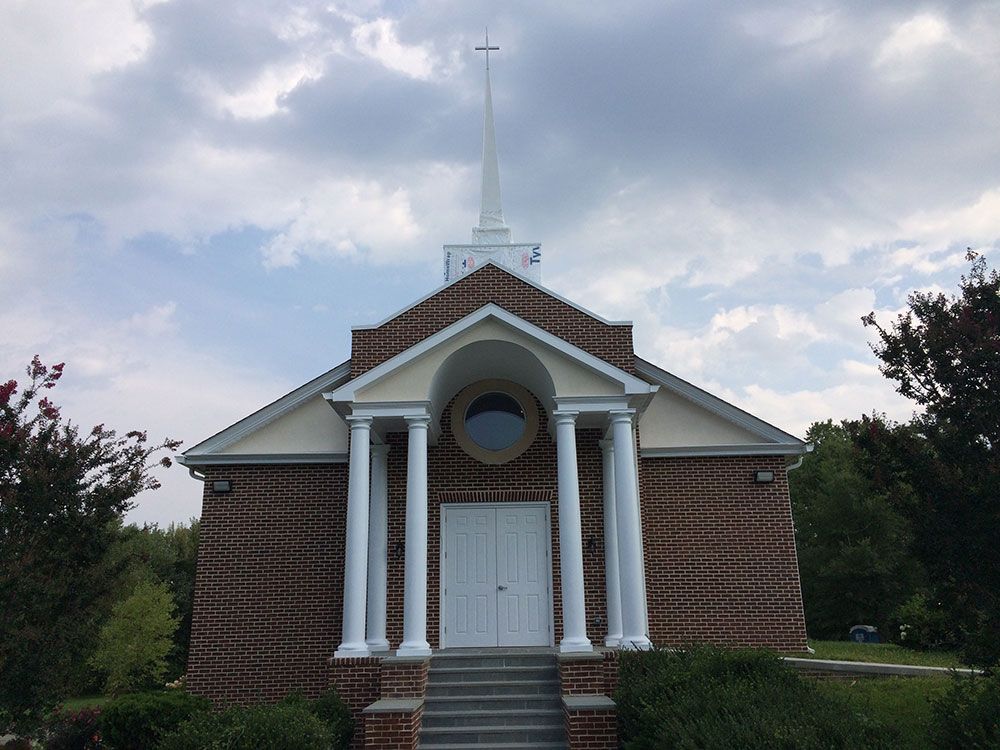 A small church with a cross on top of it