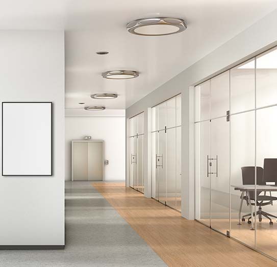 A hallway with glass doors and a picture on the wall