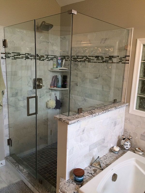 A bathroom with a walk in shower and a bathtub.