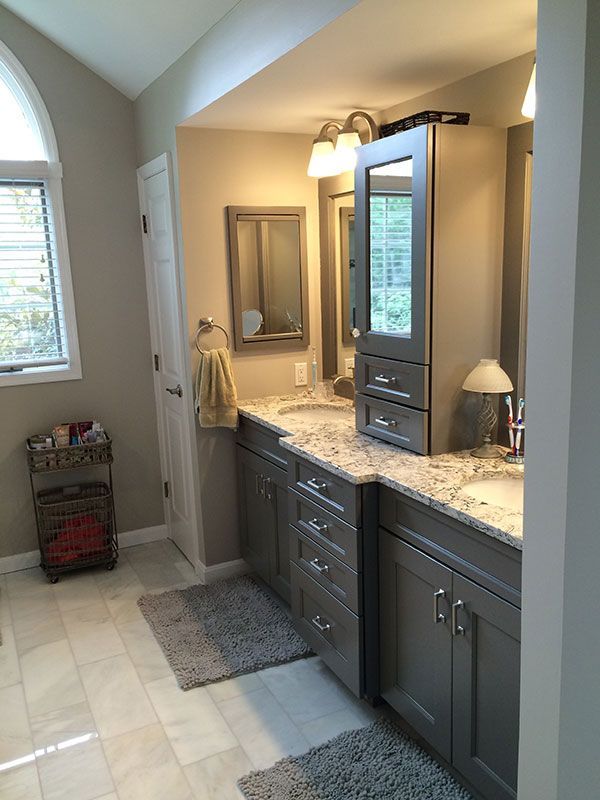 A bathroom with two sinks and two mirrors