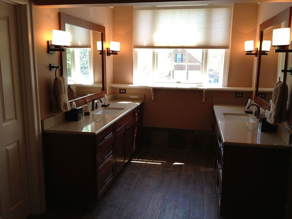 A bathroom with two sinks and two mirrors