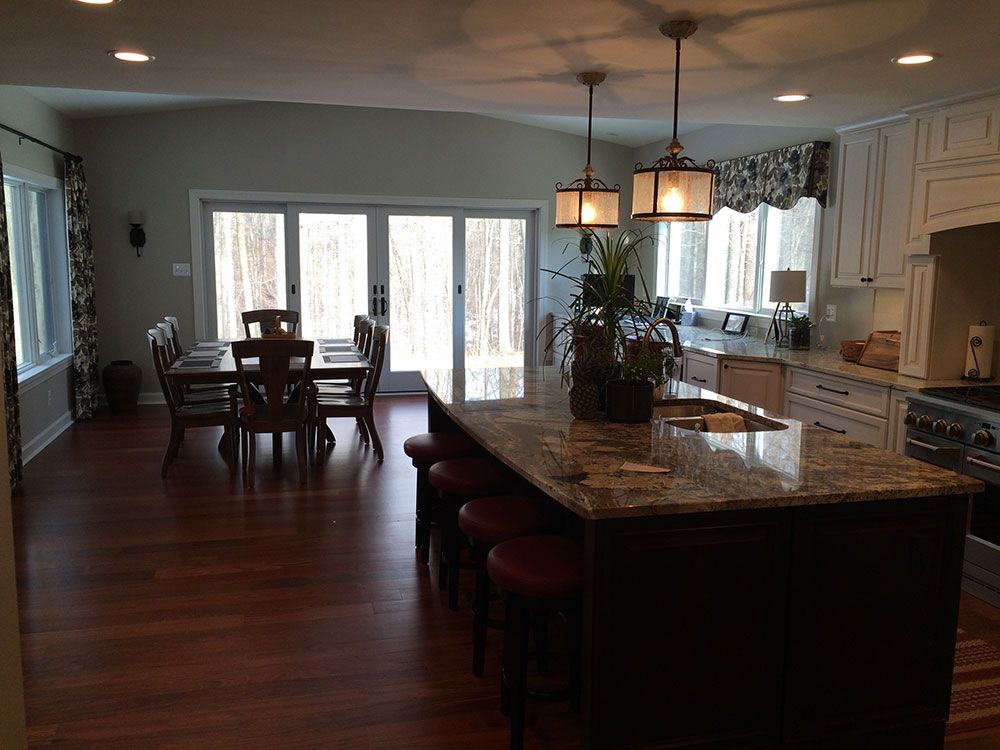 A kitchen with a large island and a dining table