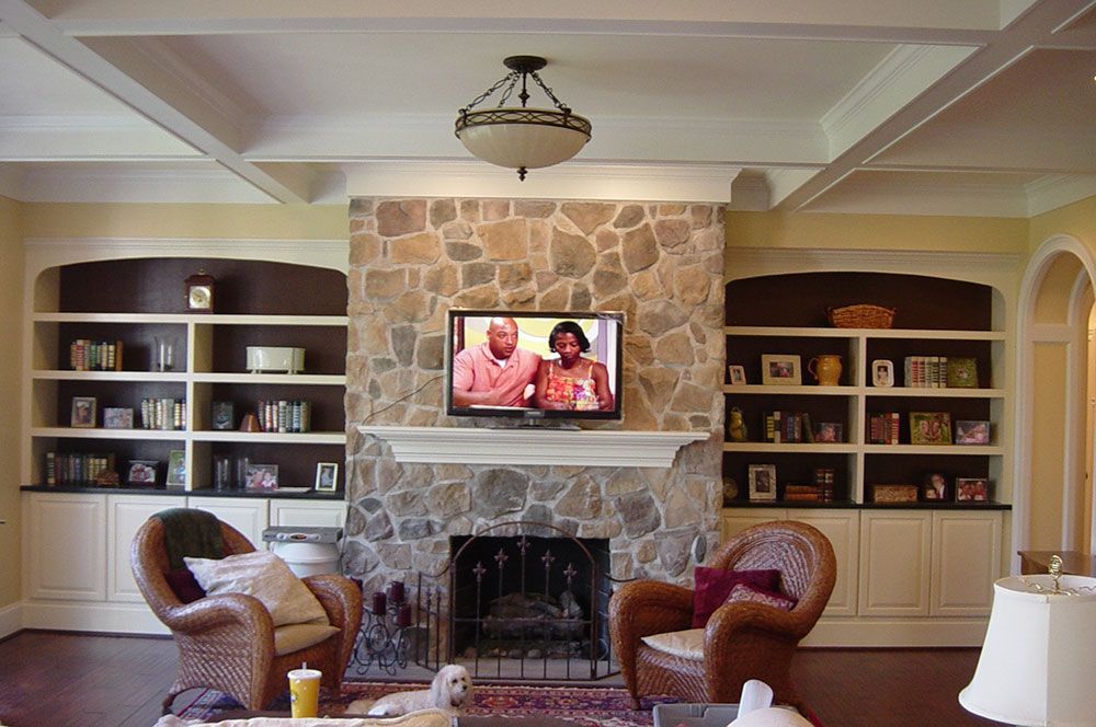 A living room with a fireplace and a flat screen tv