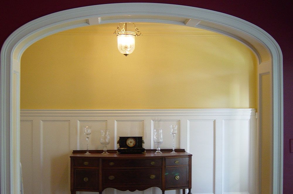 A room with a dresser and a clock on it