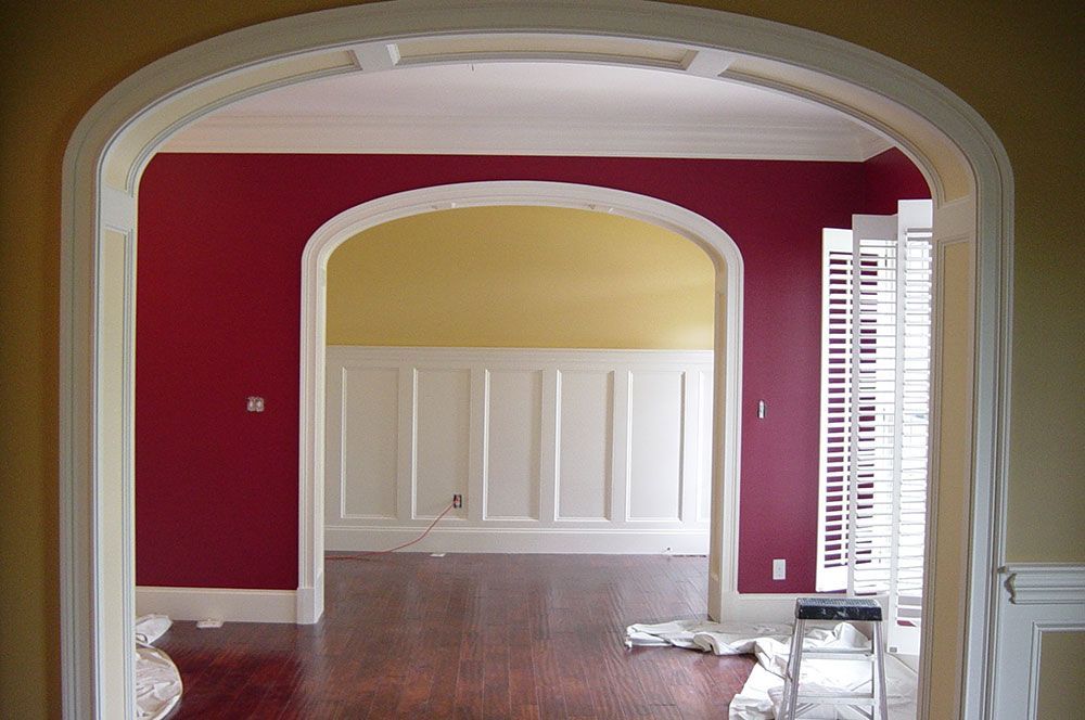 A room with red and yellow walls and white trim