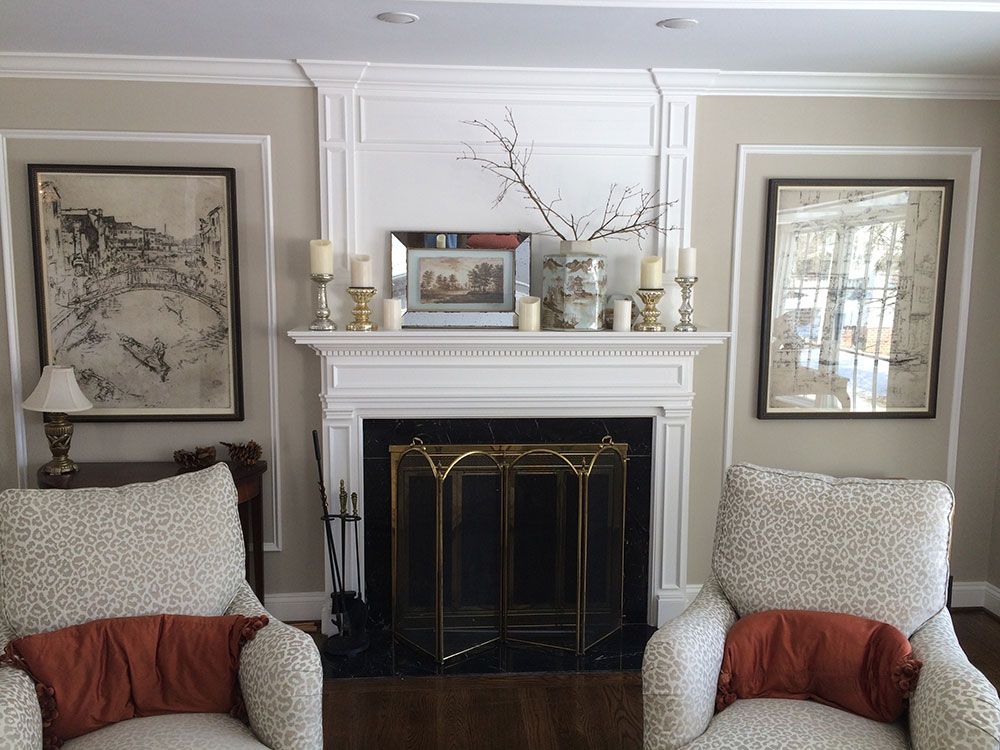 A living room with two chairs and a fireplace