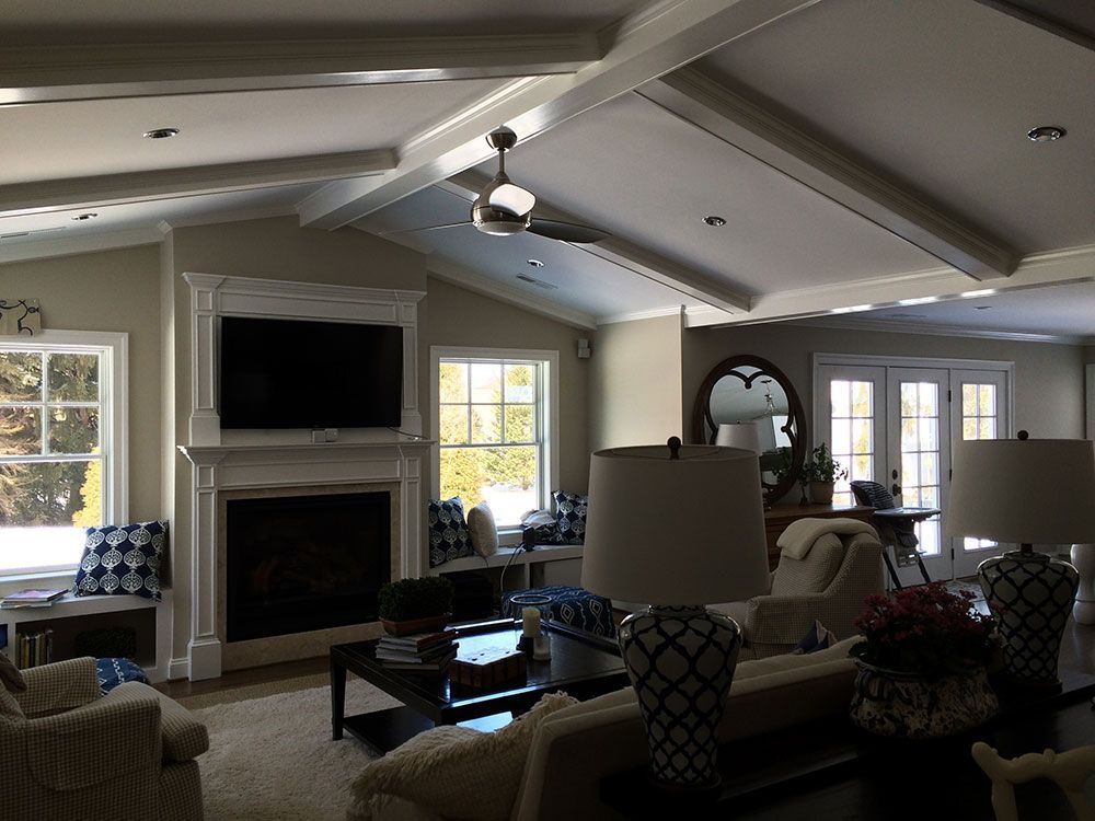 A living room with a fireplace and a flat screen tv