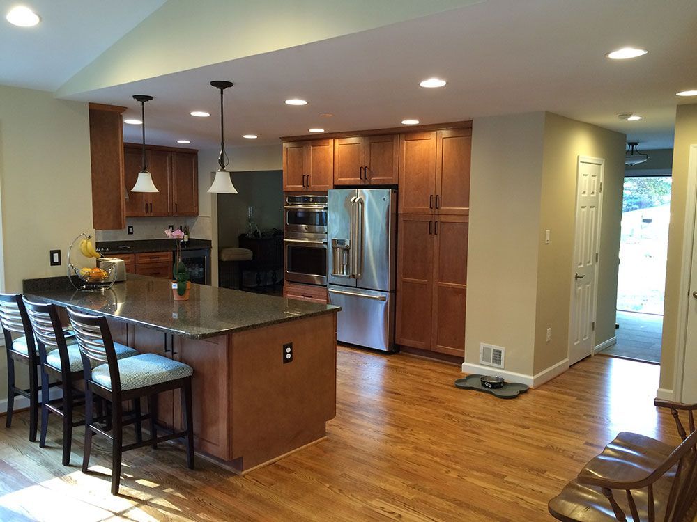 A kitchen with stainless steel appliances and wooden cabinets