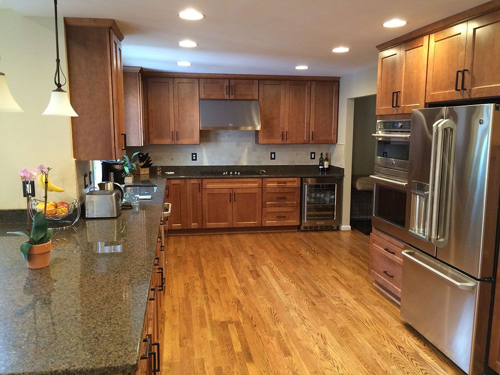 A kitchen with stainless steel appliances and wooden cabinets