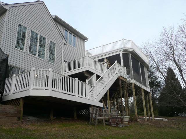 A house with a large deck and screened in porch