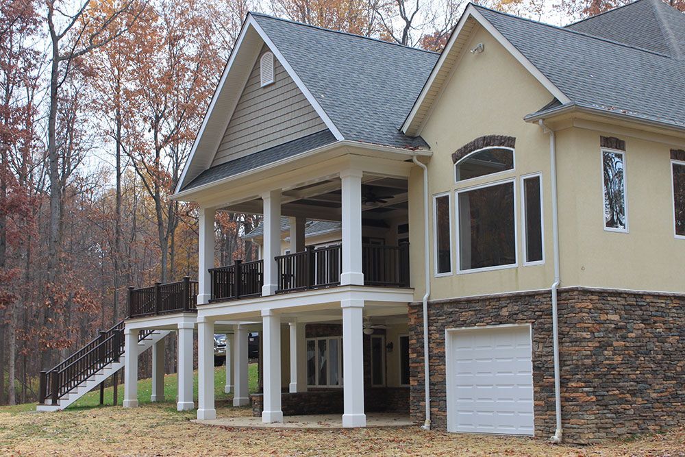 A large house with a large porch and a garage