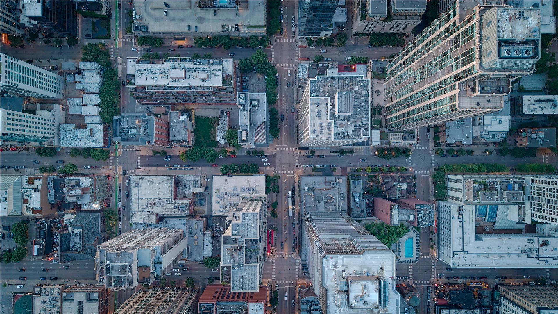 Aerial view of a dense city block with tall buildings and streets below.
