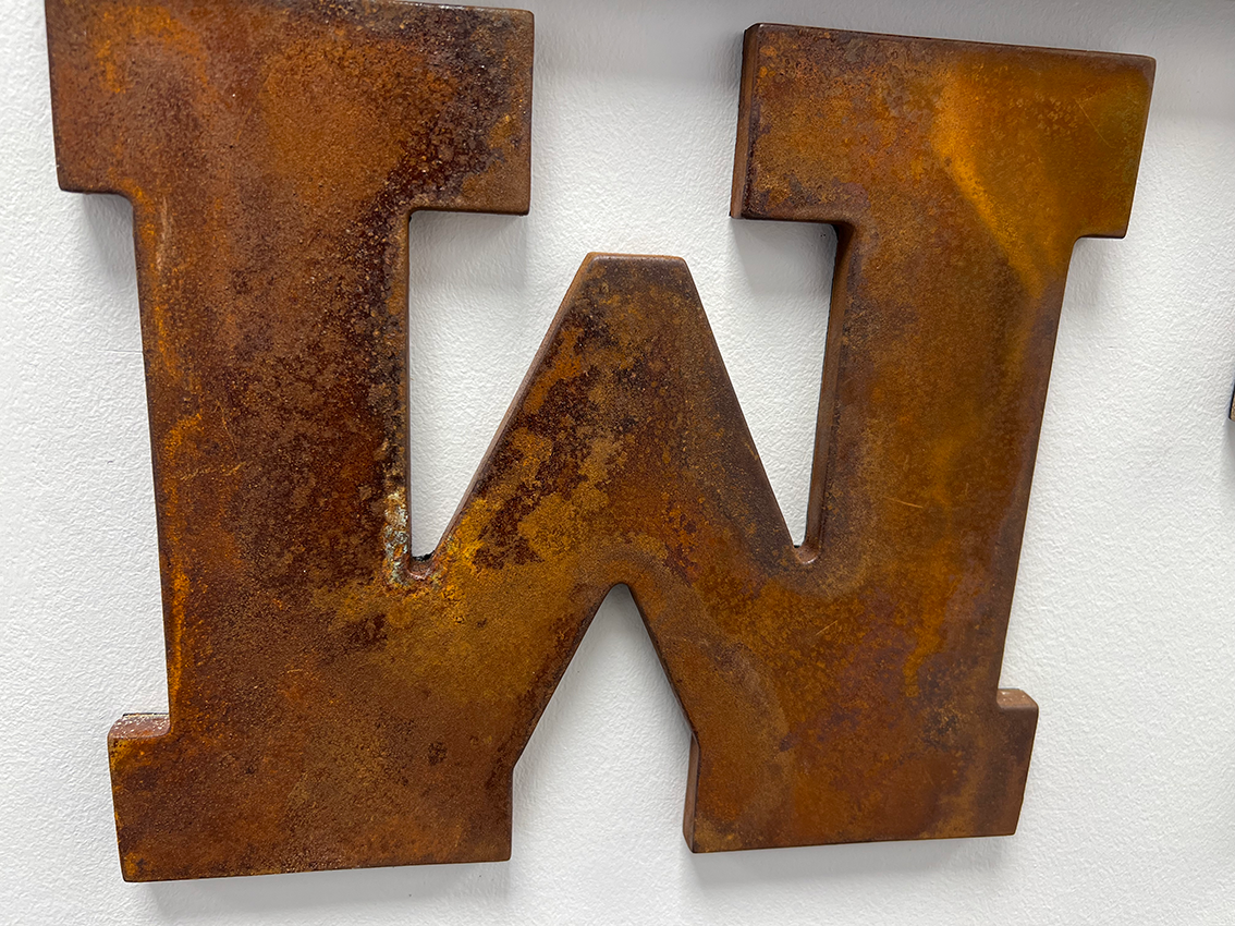Cut letters sign in rust effect finish