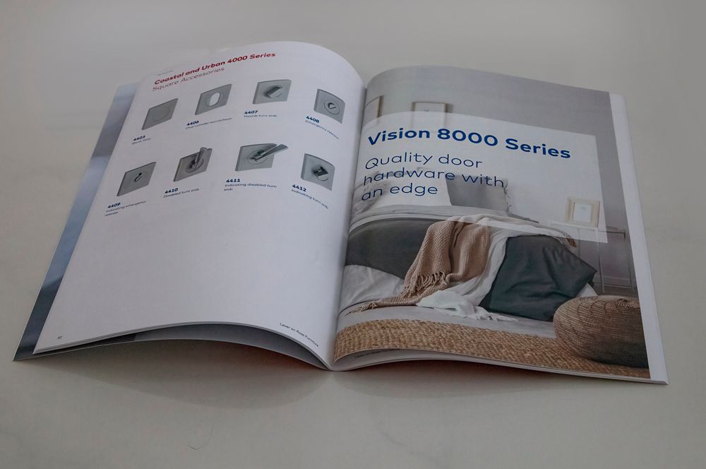 Open brochure showcasing door designs and a living room with text: