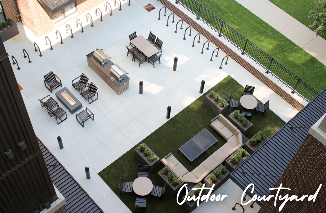 Overhead view of an outdoor courtyard with seating areas, a fire pit, and bike racks.