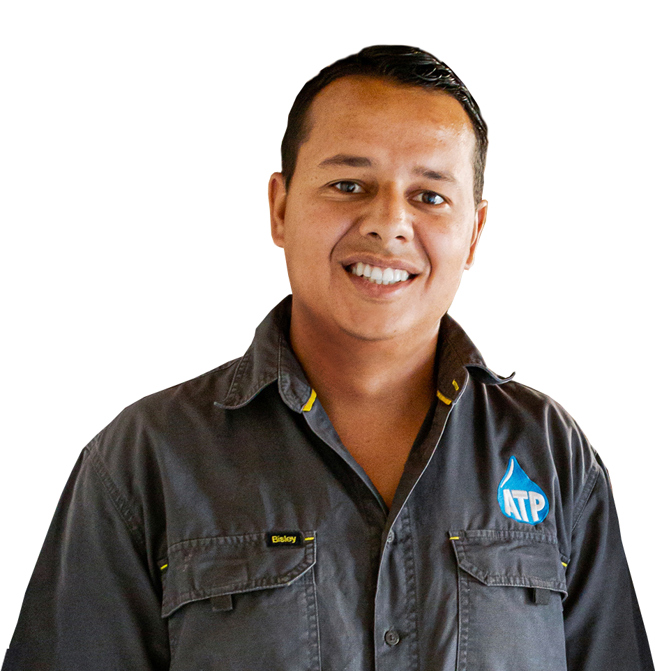 A man wearing a ktp shirt smiles for the camera