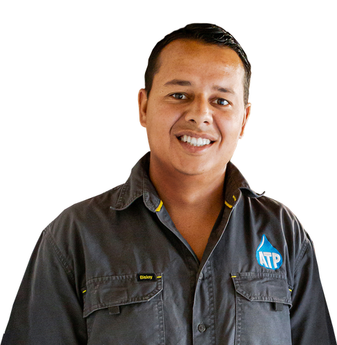A man wearing a ktp shirt smiles for the camera
