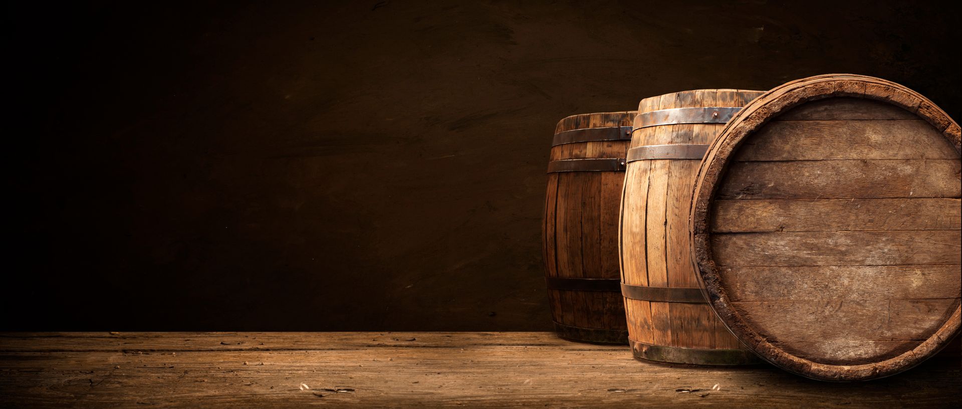 Two wooden barrels are sitting on a wooden table.