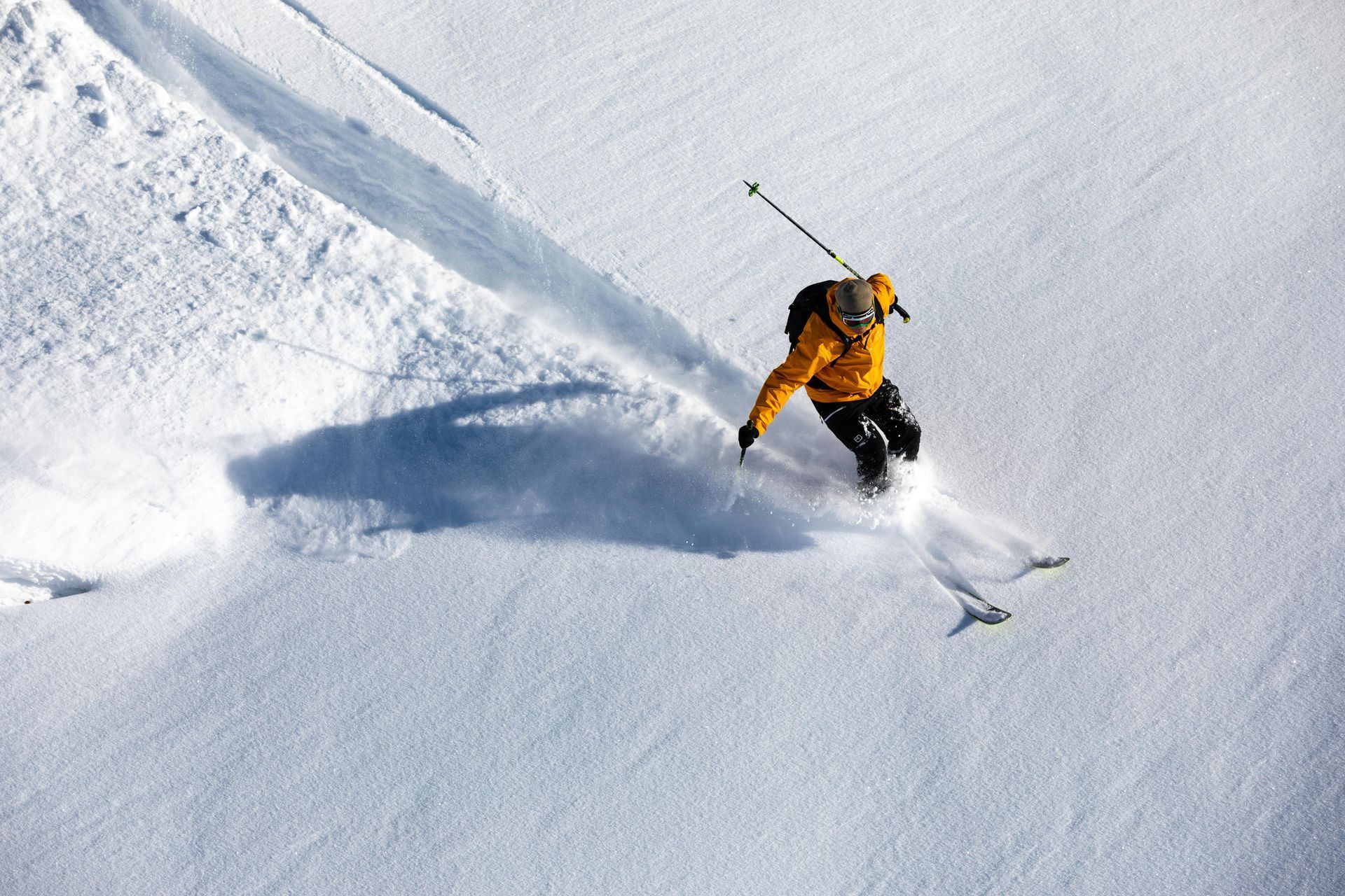 A person is skiing down a snow covered slope.