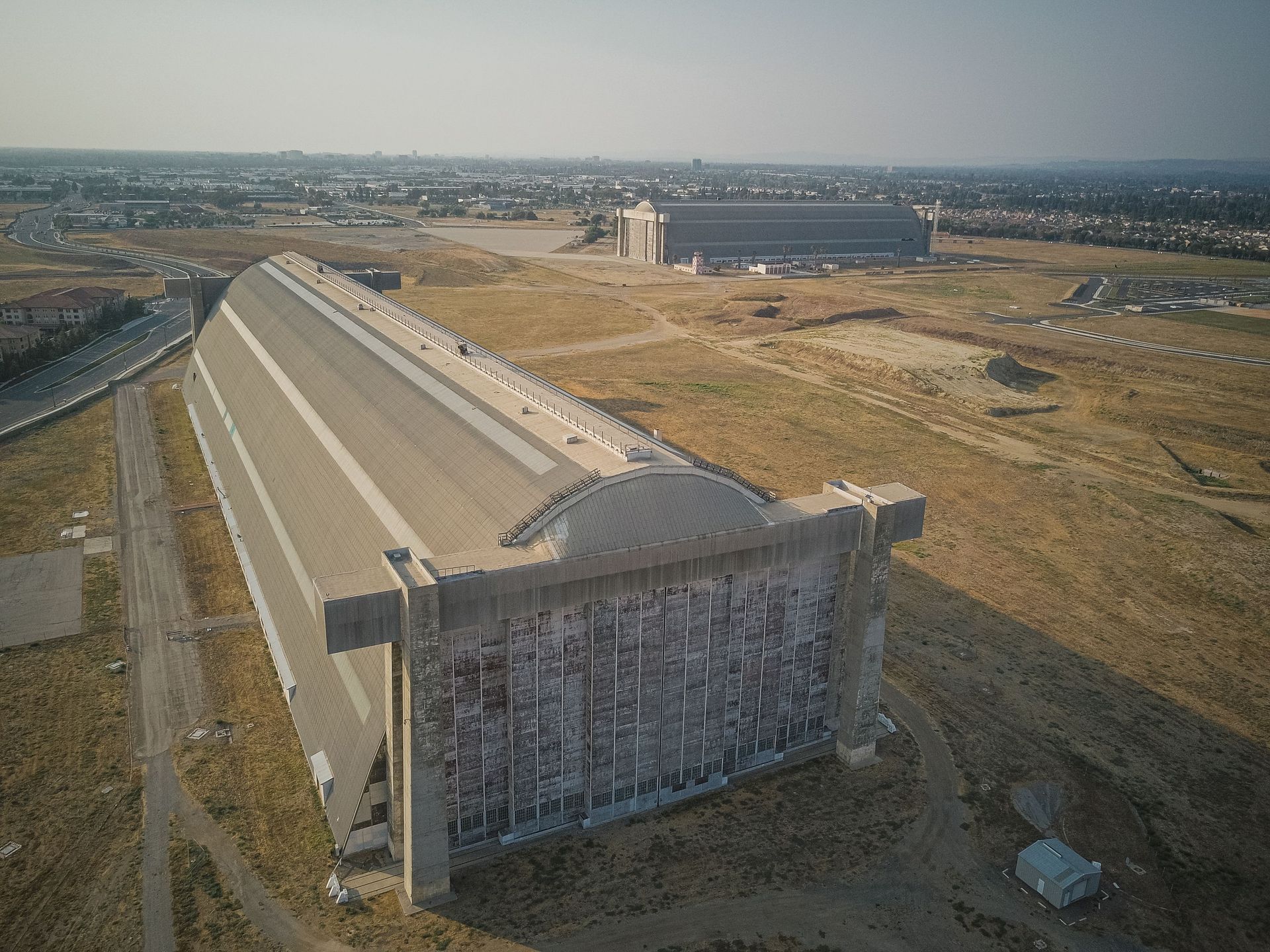 Aerial view of airport runways and hangars illustrating airport travel planning