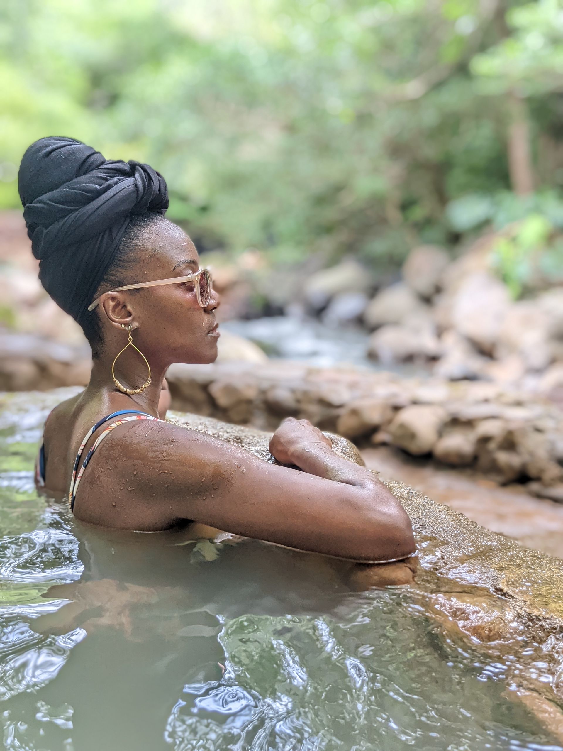 Amber isolated and relaxing in a head wrap in the hot springs at Guachipelin , Guanacaste