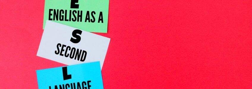 Three stacked, colorful sticky notes on a red background, forming the acronym
