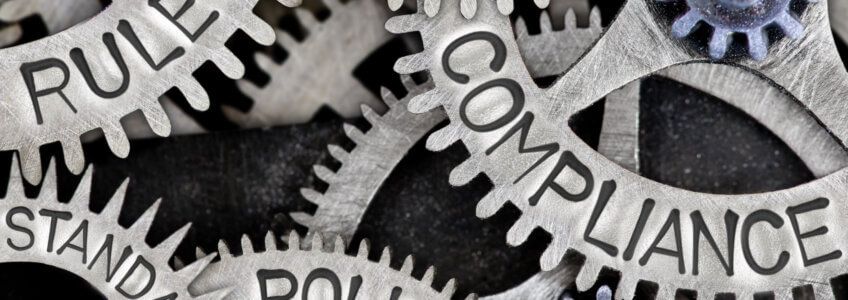 Close-up of interlocking metal gears featuring the words