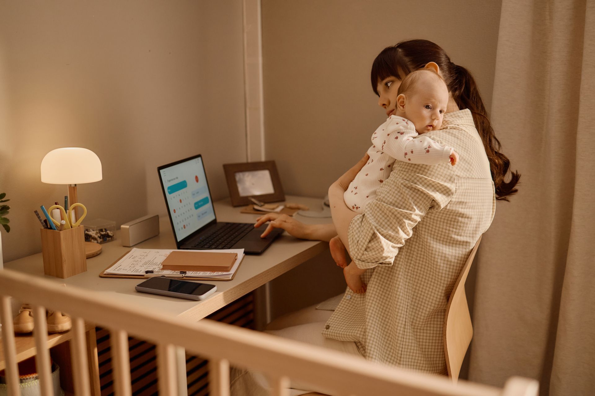 woman holding baby while working