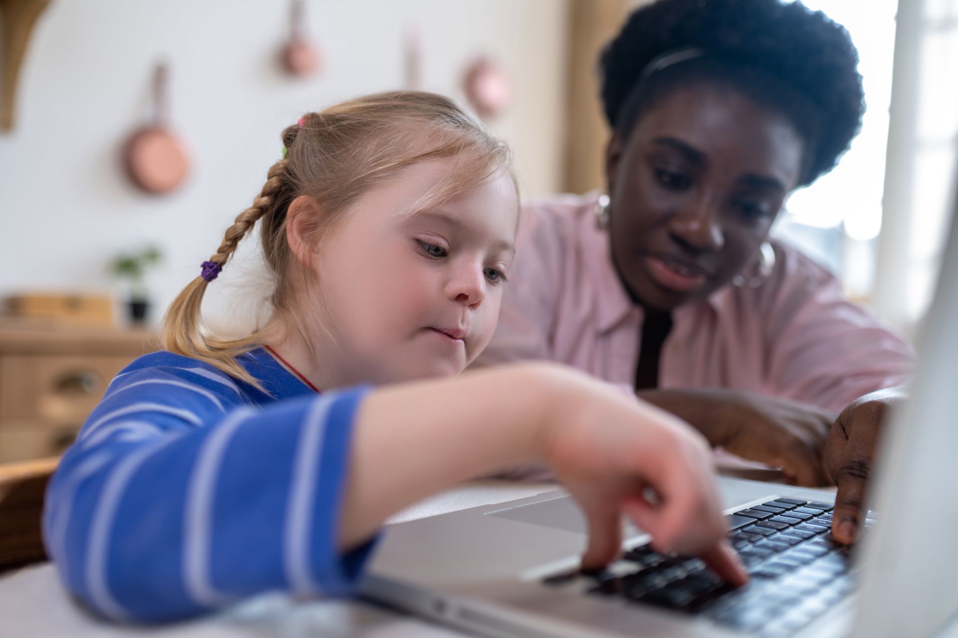 child with down syndrome working with teacher in Minnesota