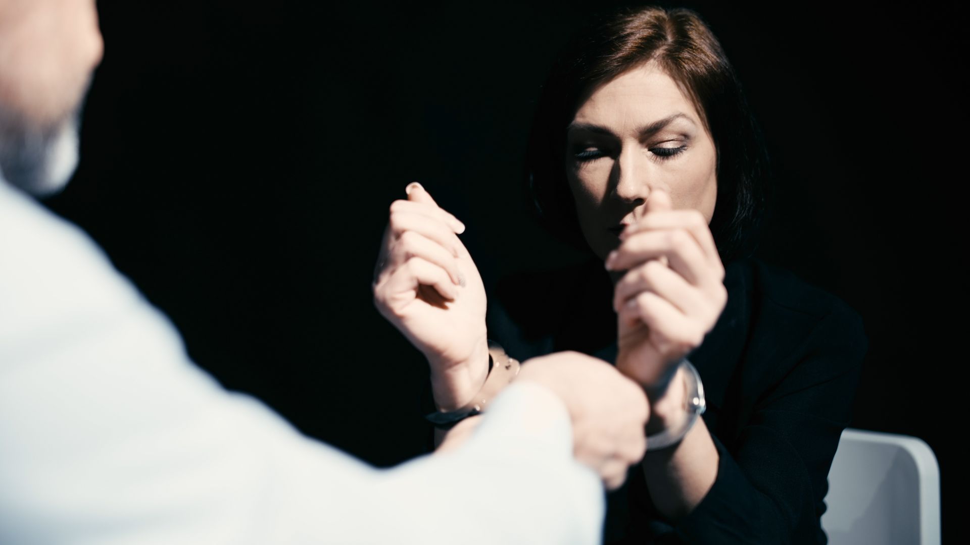 wrongful detention woman getting cuffs taken off