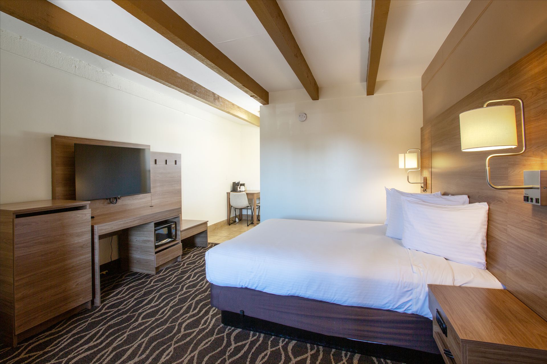 Spacious Dreamcatcher Inn Sedona room with king bed and flat-screen TV for a relaxing stay