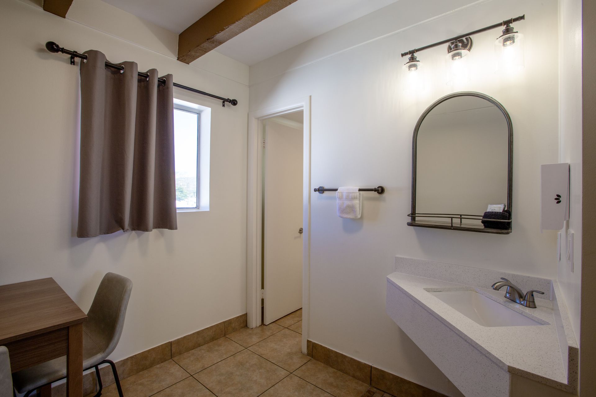 Modern bathroom at Dreamcatcher Inn Sedona featuring sink, mirror, and vanity table